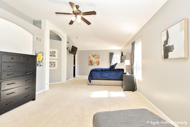 bedroom with visible vents, baseboards, ceiling fan, vaulted ceiling, and light colored carpet