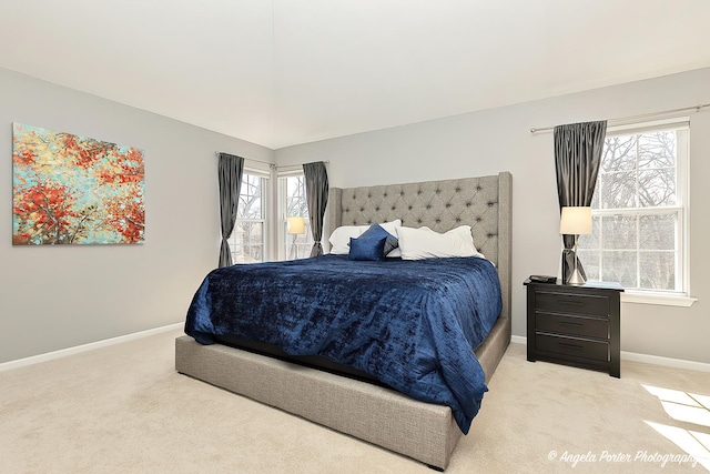 bedroom featuring baseboards and light carpet