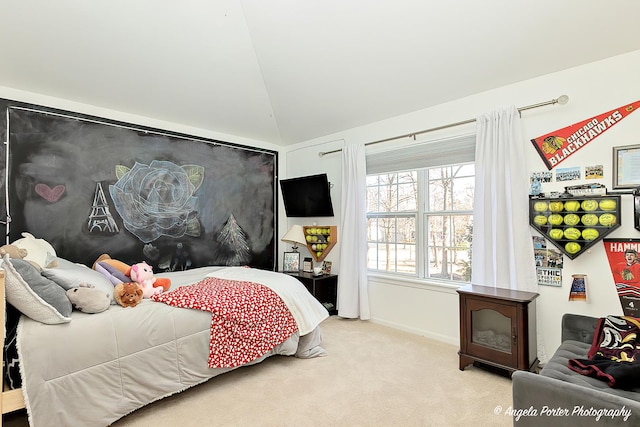 carpeted bedroom with lofted ceiling