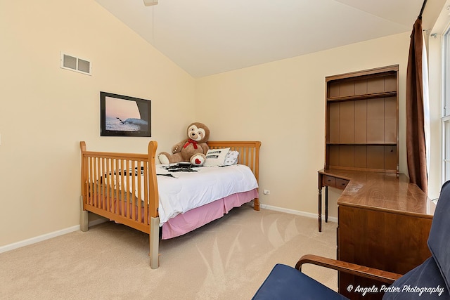 carpeted bedroom with vaulted ceiling, baseboards, and visible vents