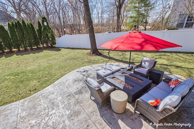 view of patio / terrace with an outdoor living space with a fire pit and fence