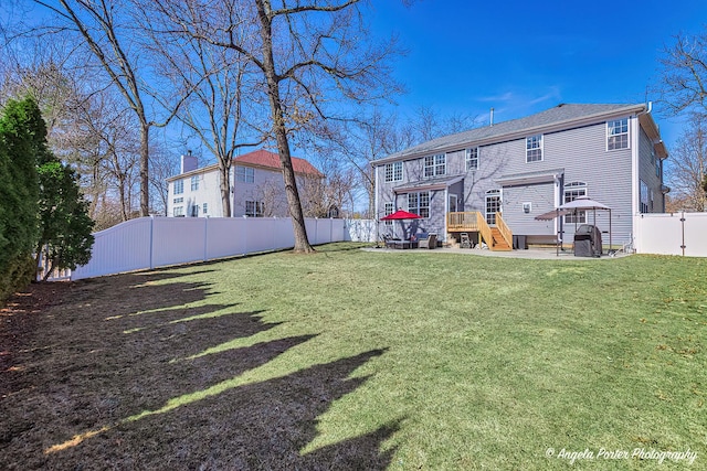 back of house featuring a yard, a patio, and a fenced backyard