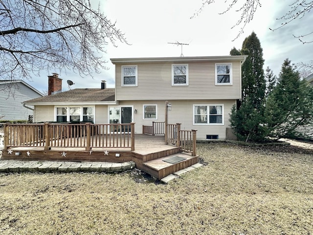 rear view of house featuring a chimney and a deck