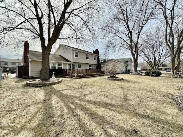 view of yard featuring a deck and a fire pit