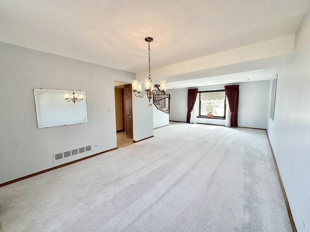 empty room featuring visible vents, a notable chandelier, light colored carpet, baseboards, and baseboard heating