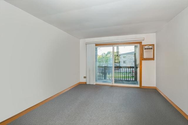 carpeted empty room featuring baseboards