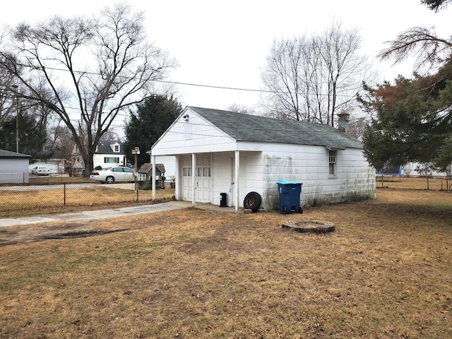 exterior space featuring concrete driveway, an outdoor structure, and fence