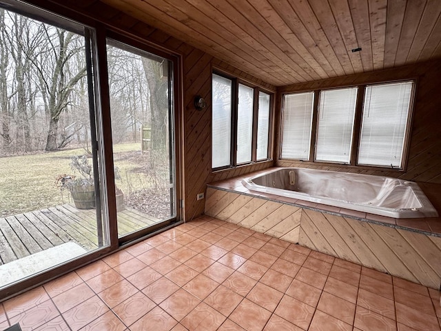 unfurnished sunroom featuring wooden ceiling and a hot tub