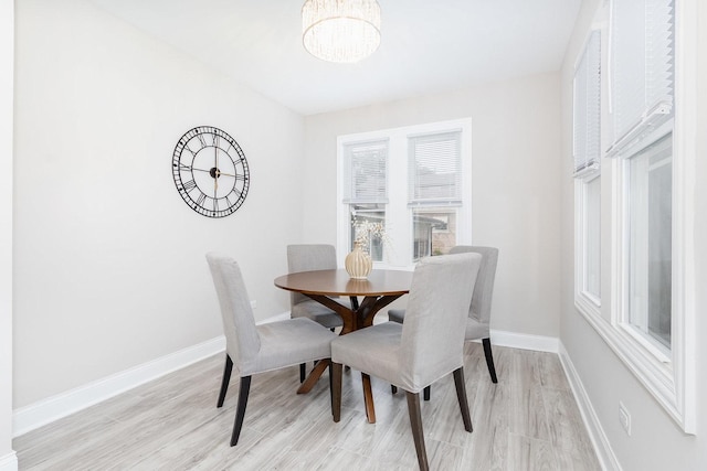 12533 S Lowe Ave, Chicago, IL 60628 - dining room featuring light wood finished floors, a chandelier, and baseboards