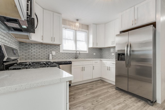 12533 S Lowe Ave, Chicago, IL 60628 - kitchen with stainless steel appliances, tasteful backsplash, and white cabinets