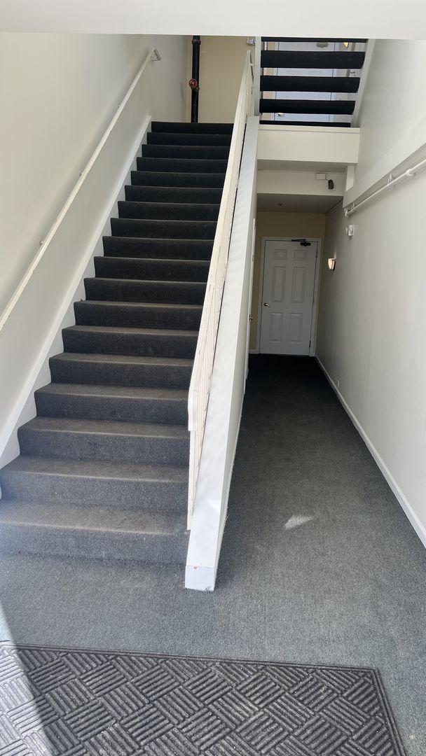 staircase with carpet flooring and baseboards