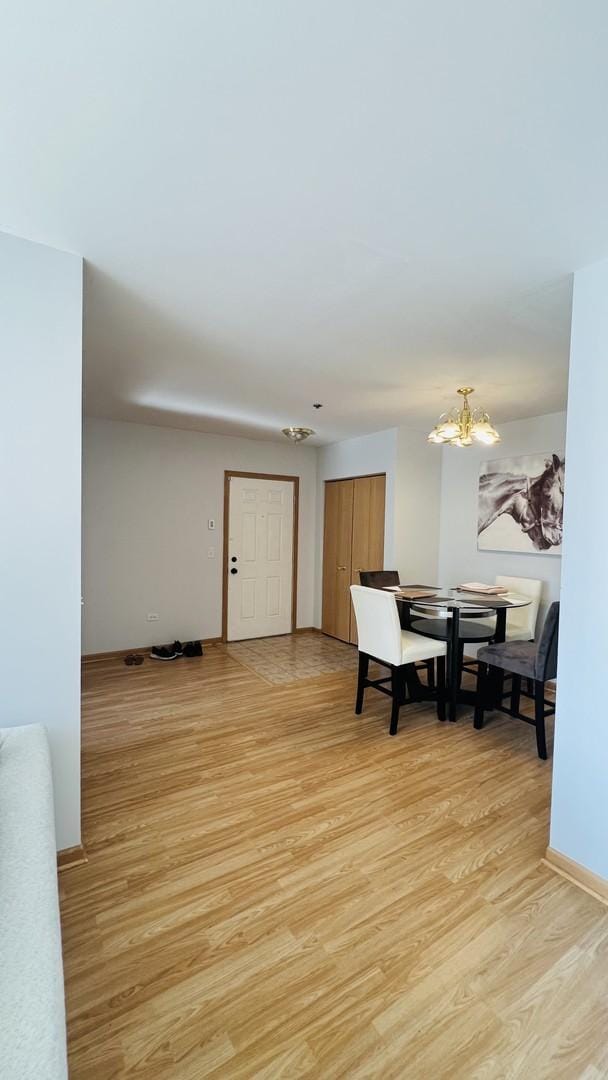 dining space with an inviting chandelier and light wood-style flooring