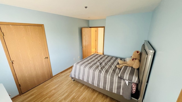 bedroom with wood finished floors and baseboards