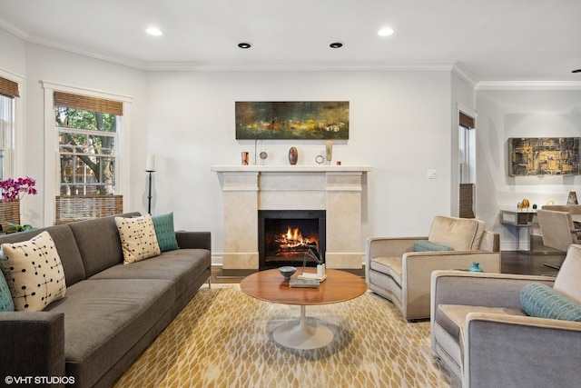 living room with wood finished floors, baseboards, a premium fireplace, recessed lighting, and crown molding