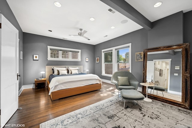 bedroom with wood finished floors, visible vents, baseboards, recessed lighting, and beamed ceiling