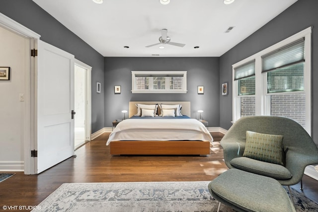 bedroom featuring wood finished floors, visible vents, and baseboards