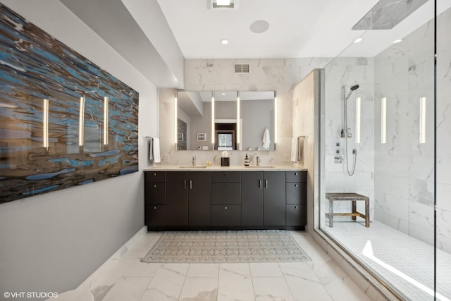 bathroom featuring a sink, visible vents, a marble finish shower, and marble finish floor