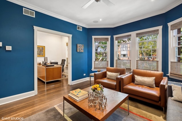 interior space featuring crown molding, wood finished floors, visible vents, and baseboards