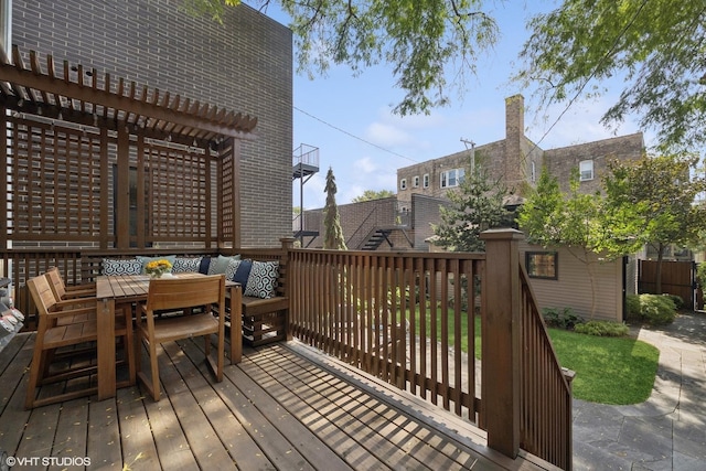 wooden deck with outdoor dining space and a pergola