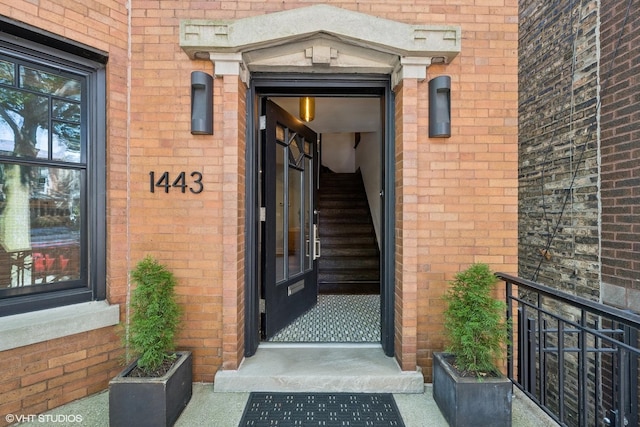 doorway to property featuring brick siding