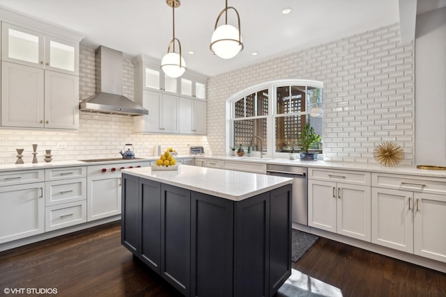 kitchen featuring white cabinetry, wall chimney exhaust hood, dark wood-type flooring, and stainless steel dishwasher