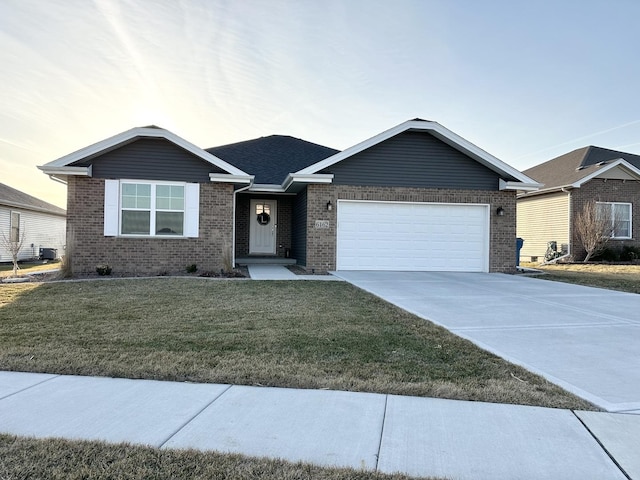 ranch-style house featuring brick siding, an attached garage, driveway, and a front yard