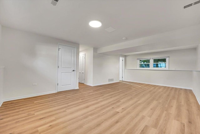 spare room featuring visible vents, light wood-type flooring, and baseboards