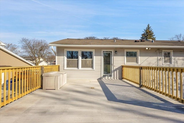 back of house featuring a wooden deck