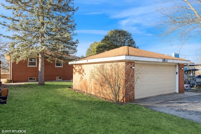 view of property exterior featuring an outdoor structure, a yard, and brick siding