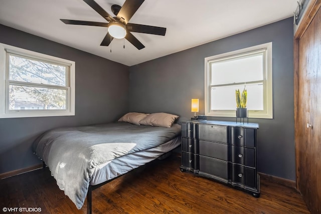 bedroom with a ceiling fan, baseboards, and wood finished floors