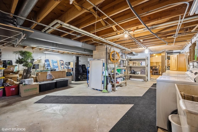 unfinished basement featuring separate washer and dryer and a sink