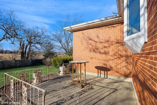 wooden deck featuring a lawn and fence