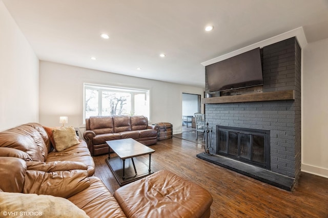 living area with a brick fireplace, recessed lighting, wood finished floors, and baseboards