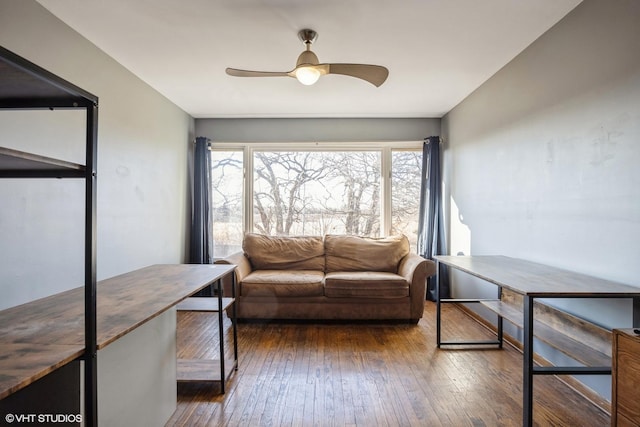 living area featuring hardwood / wood-style flooring and ceiling fan