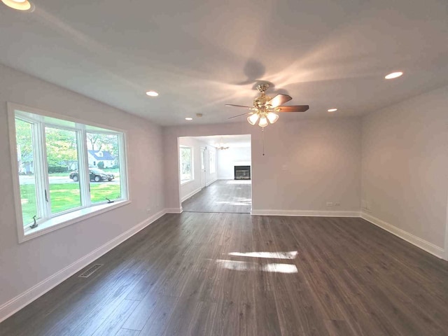 spare room featuring recessed lighting, visible vents, baseboards, and dark wood finished floors