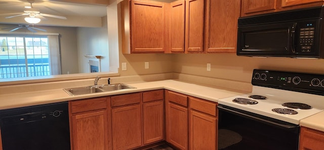 kitchen with a ceiling fan, brown cabinetry, a sink, black appliances, and light countertops