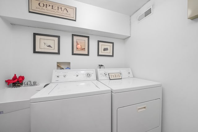 laundry area featuring visible vents, separate washer and dryer, and laundry area