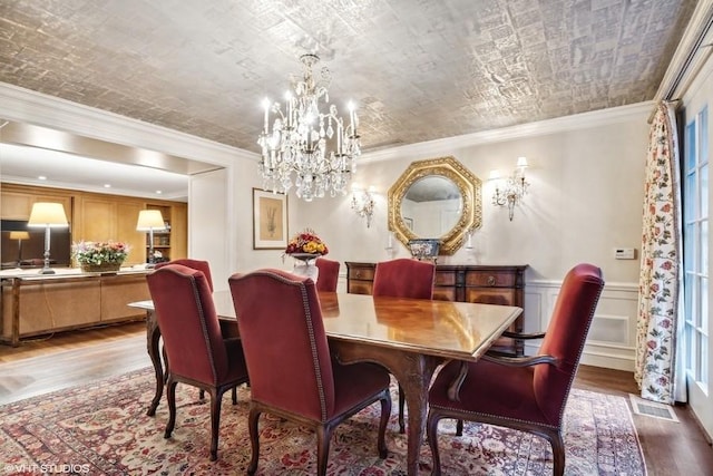 219 E Lake Shore Dr Unit 2Abc, Chicago, IL 60611 - dining area with wood finished floors, a chandelier, ornamental molding, and a wainscoted wall