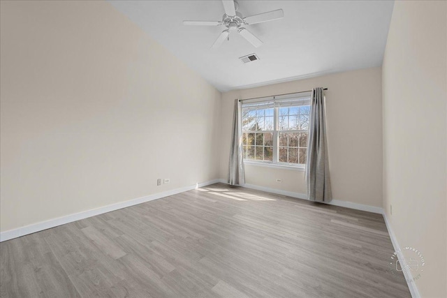 spare room featuring ceiling fan, wood finished floors, visible vents, and baseboards