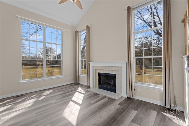 unfurnished living room with a wealth of natural light and ceiling fan