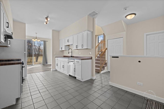 kitchen featuring a chandelier, visible vents, white cabinetry, and stainless steel dishwasher