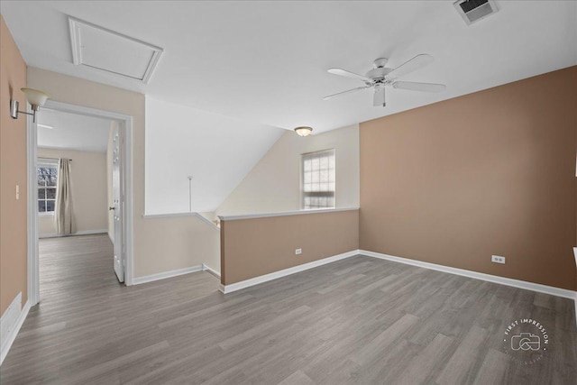 unfurnished room featuring visible vents, wood finished floors, baseboards, and ceiling fan