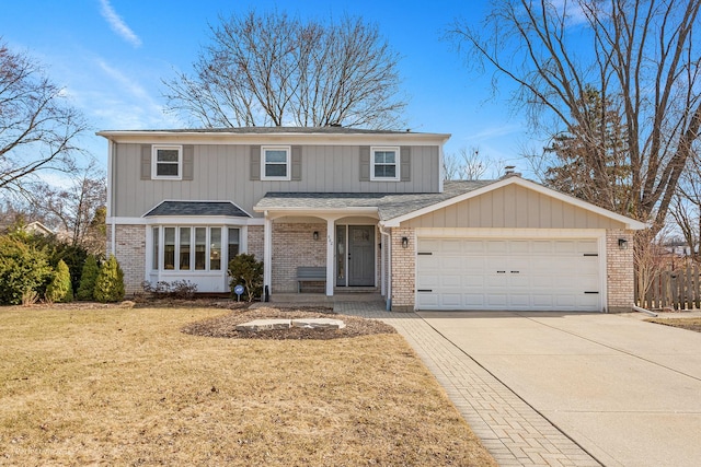 traditional-style home with an attached garage, brick siding, and driveway