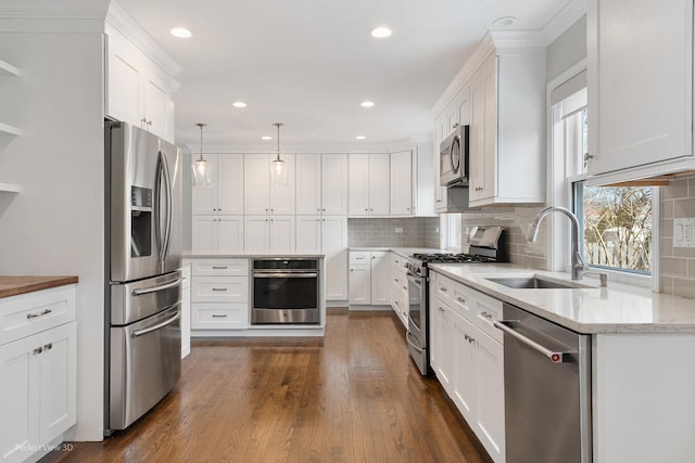 kitchen featuring a sink, stainless steel appliances, white cabinets, and dark wood-style flooring