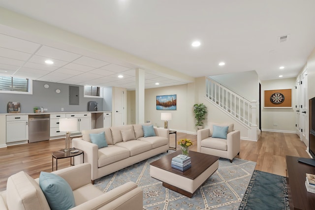 living area with stairway, light wood-style flooring, recessed lighting, and baseboards