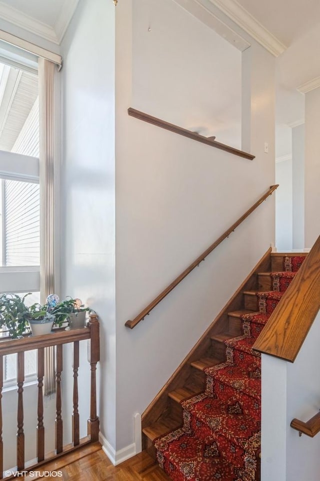 stairway featuring ornamental molding