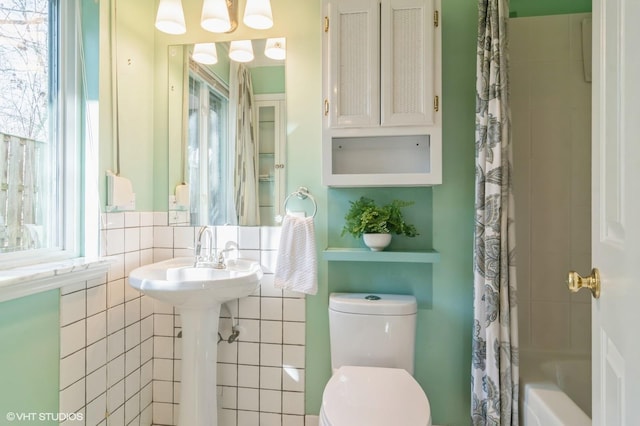 bathroom with shower / tub combo and toilet