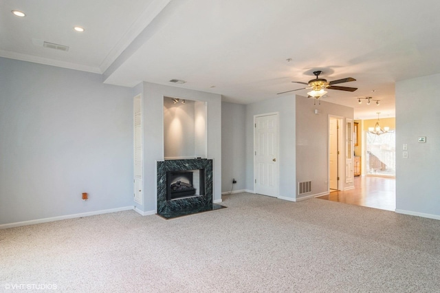 unfurnished living room with a high end fireplace, visible vents, light colored carpet, and baseboards