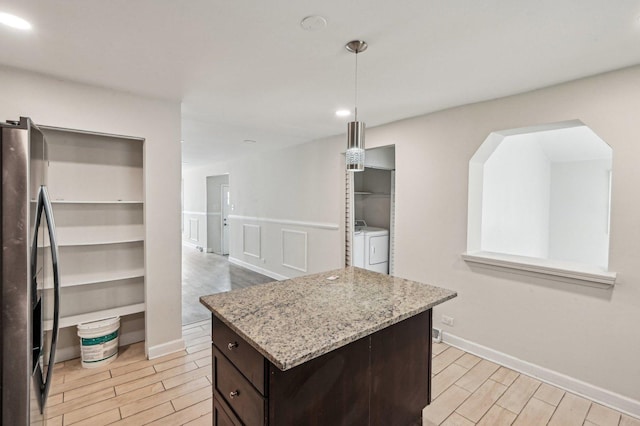 spacious closet featuring wood finish floors and washer and dryer