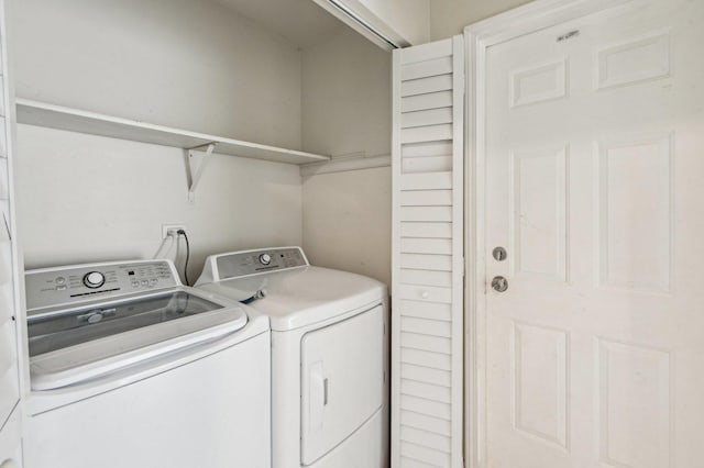 clothes washing area with independent washer and dryer and laundry area